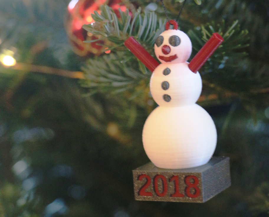 Snowman ornament hanging in our tree